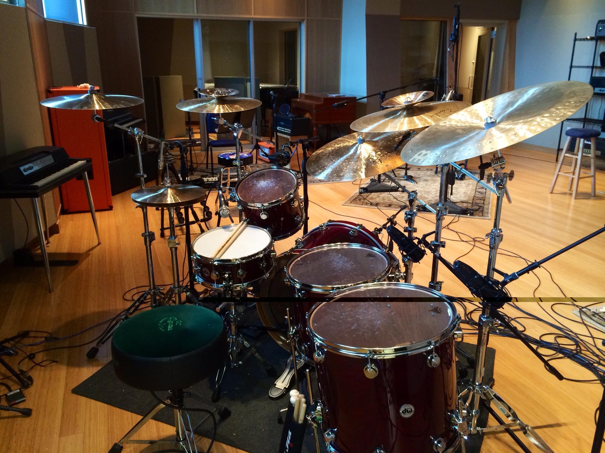 Cymbals raised higher, so they are farther from the drum mice.