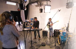 School kids playing instruments while being recorded
