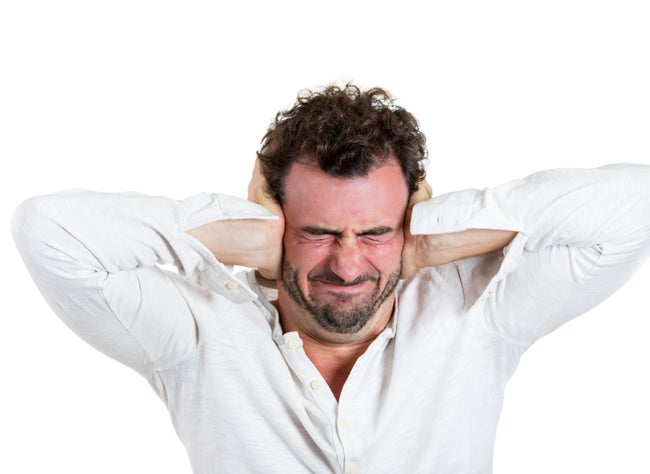 Man plugging his ears