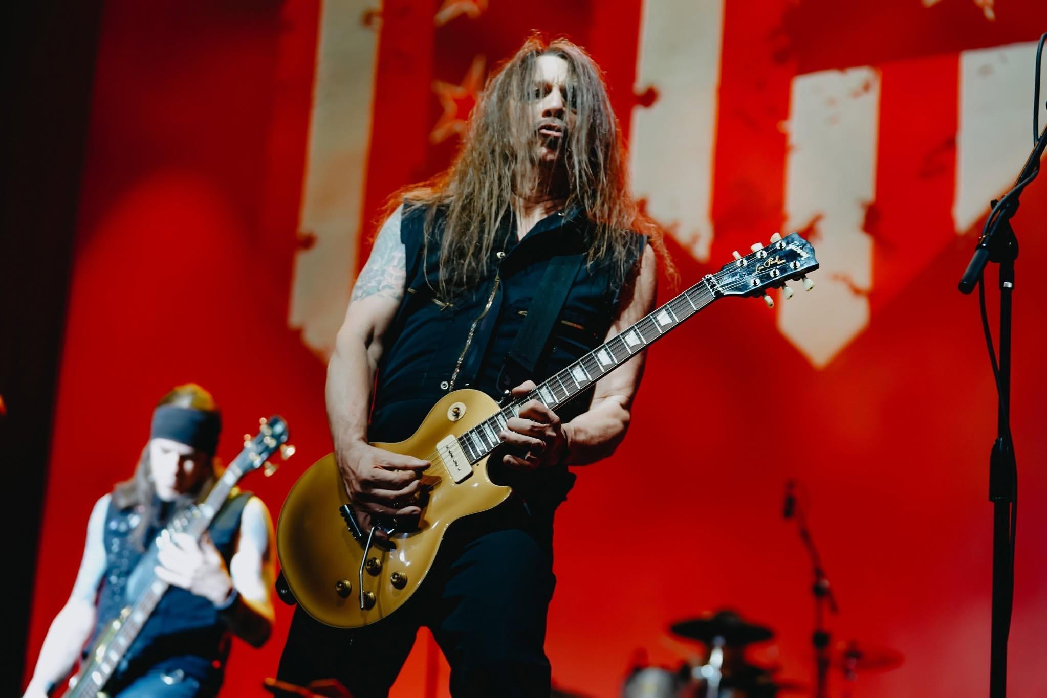 Scotti Hill playing guitar with Skid Row