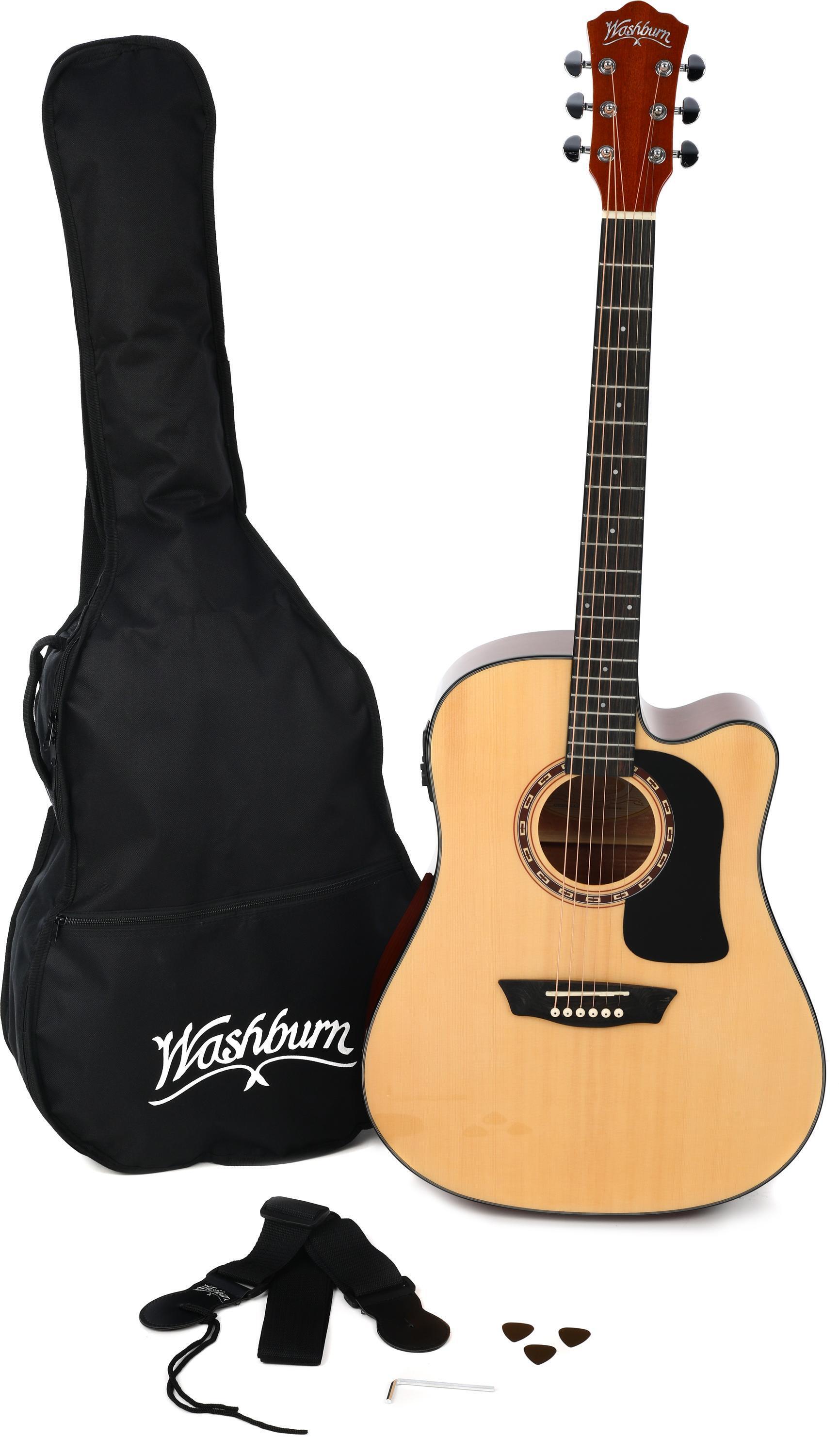 A brown acoustic guitar next to a black case, strap, and three guitar picks